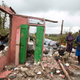 Saintanor Dutervil stands with his wife in the ruins of their home destroyed by Hurricane Matthew in Les Cayes, Haiti, Thursday, Oct. 6, 2016. Two days after the storm rampaged across the country’s remote southwestern peninsula, authorities and aid workers still lack a clear picture of what they fear is the country’s biggest disaster in years. (Image: AP)